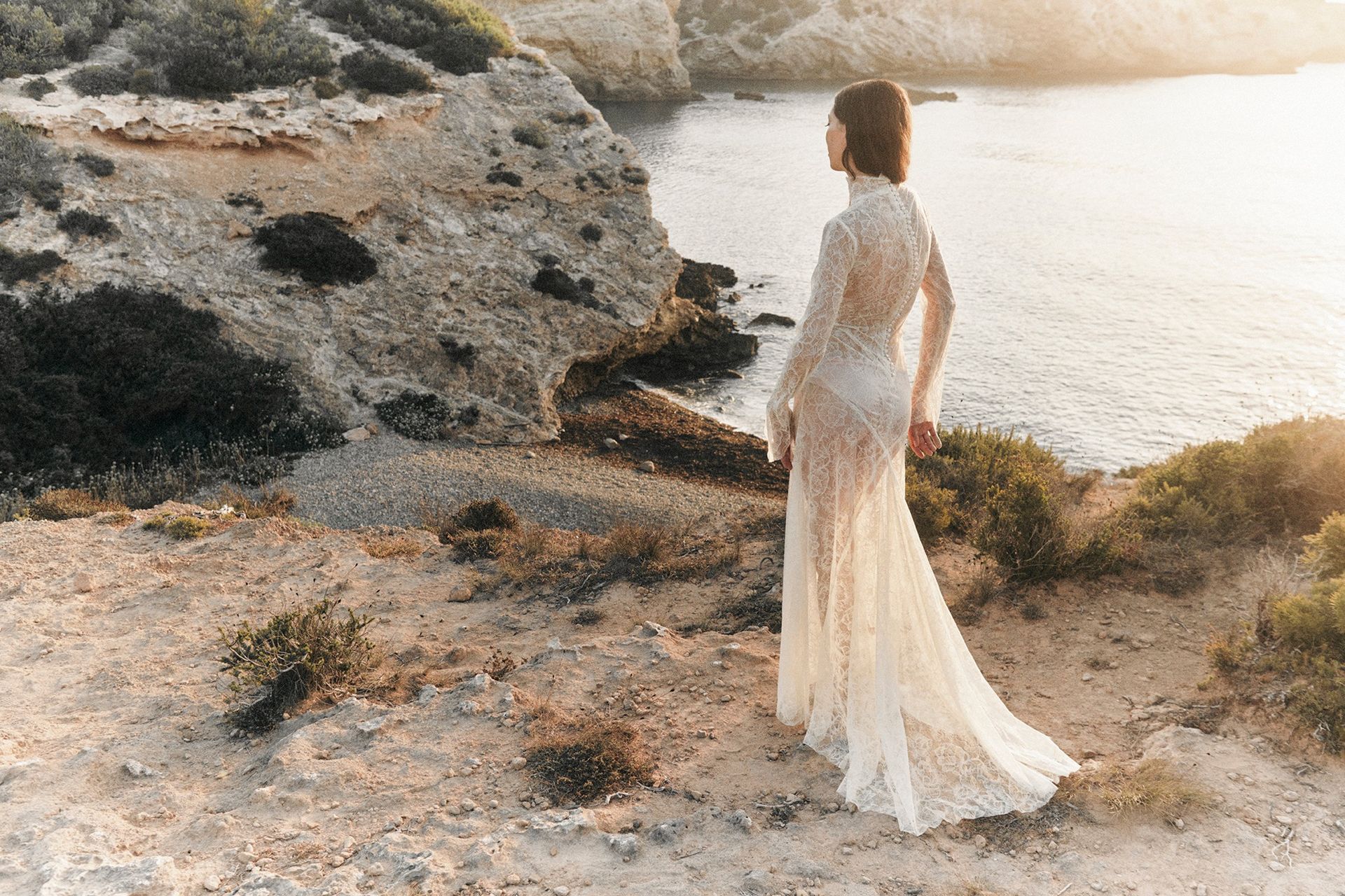 model by beach wearing wedding gown 