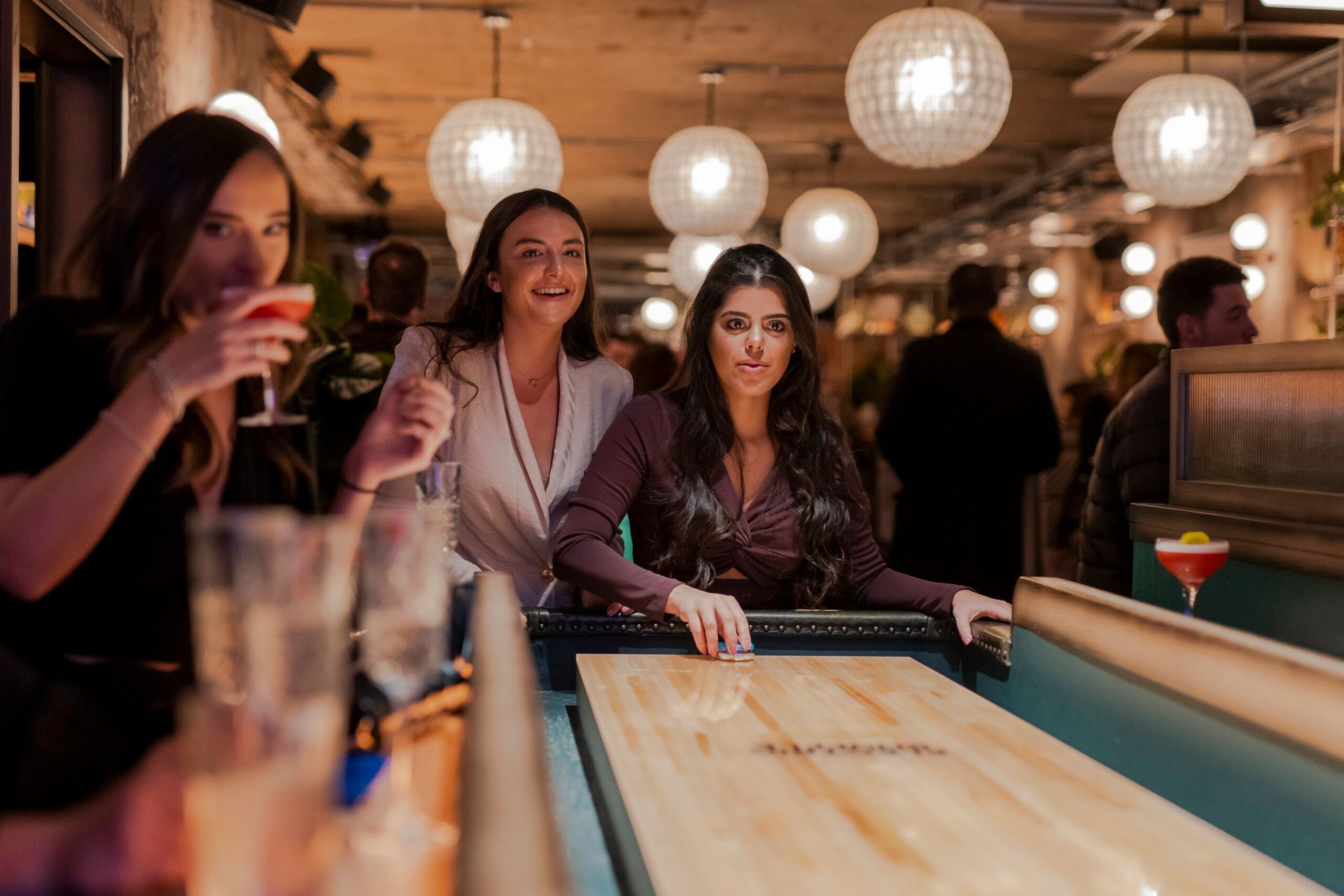 women playing shuffle board
