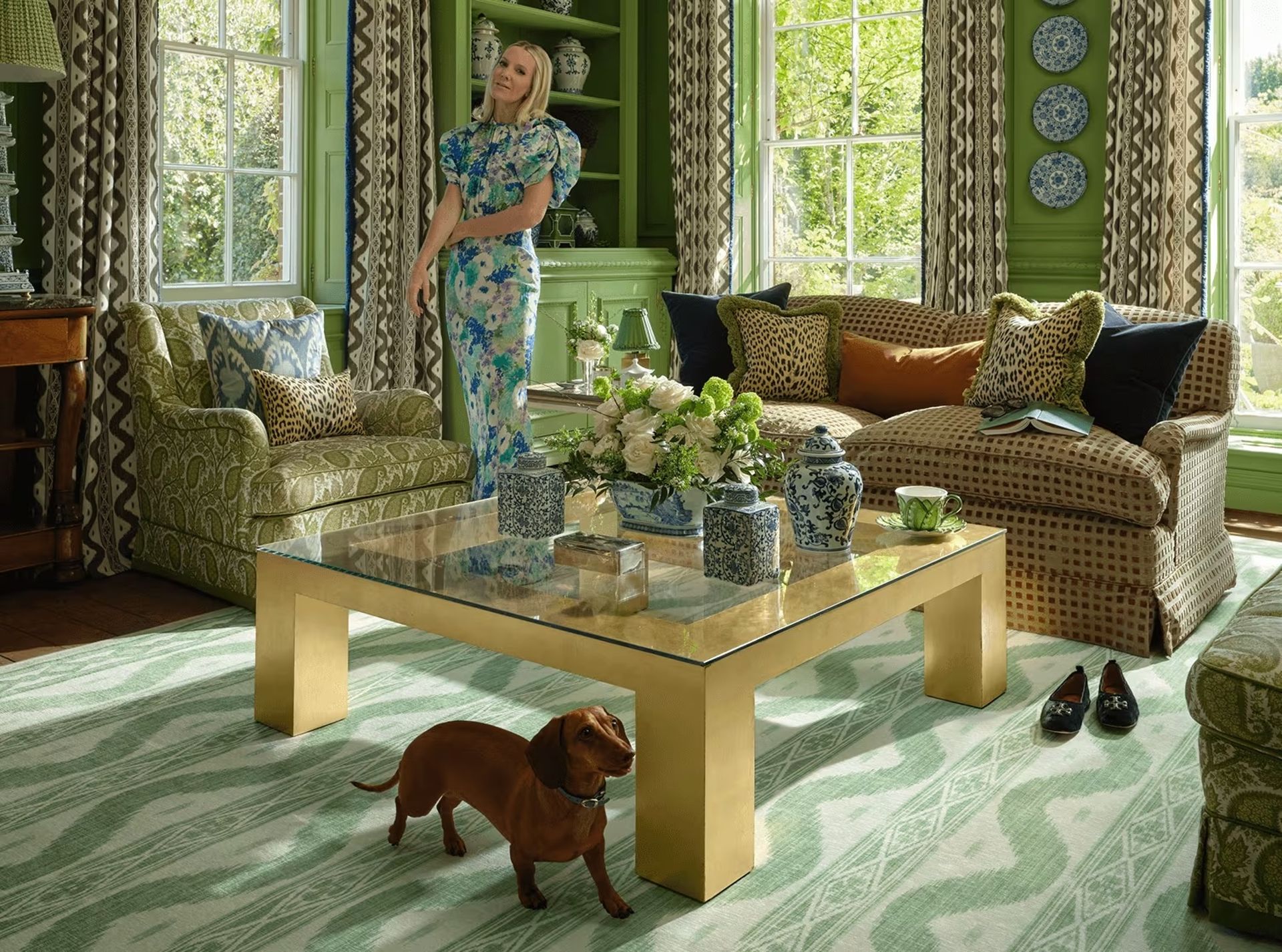 Mrs Alice in living room with sausage dog on green rug