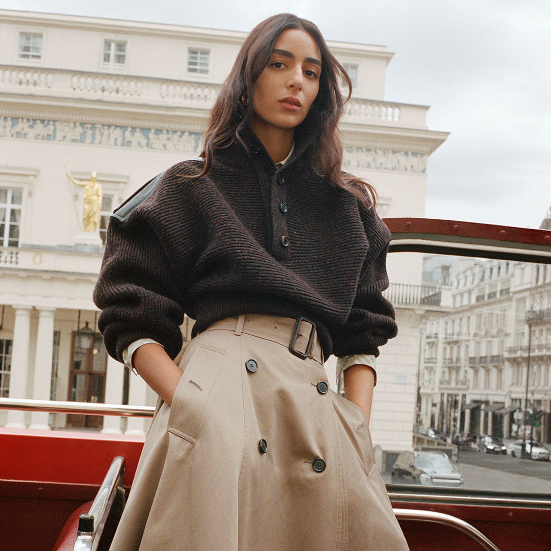 model on top deck of London bus wearing trench style skirt and knit for Bubrerry campaign 