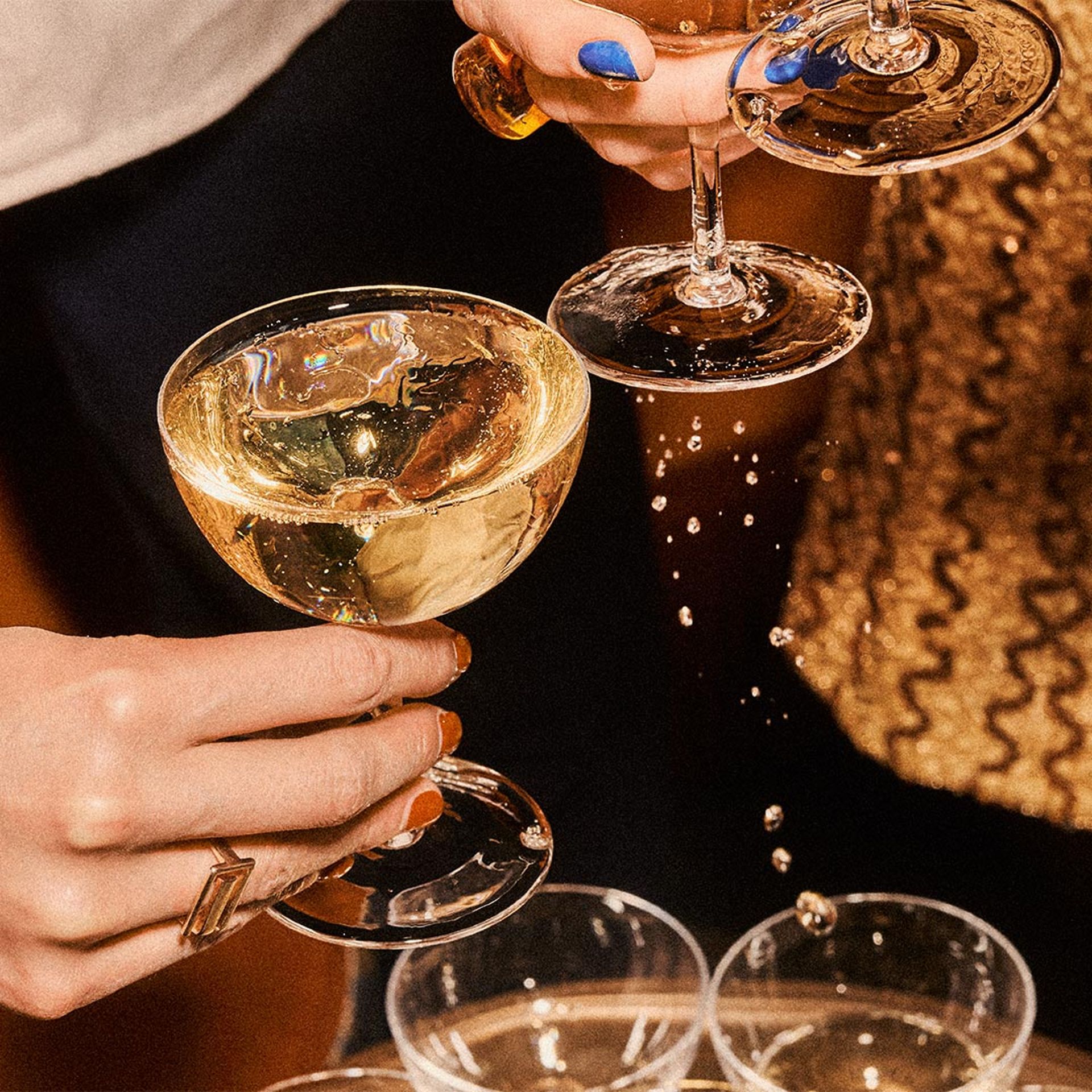 hand holding glasses of champagne