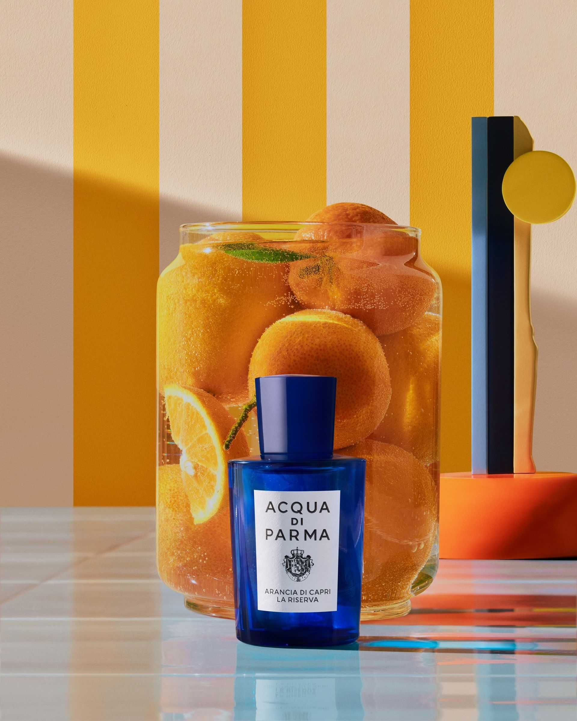 acqua di parma fragrnce bottle in front of oranges