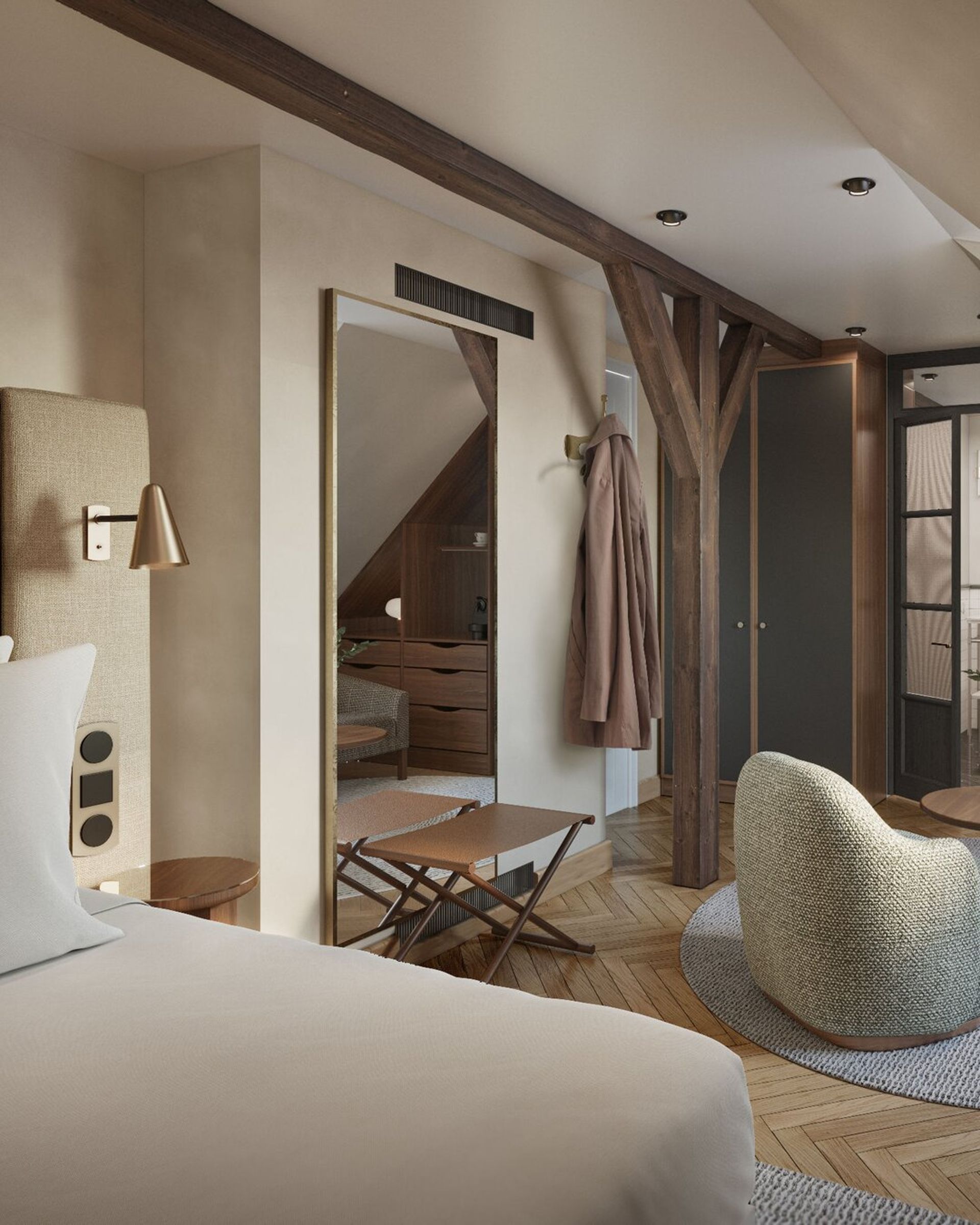 A cosy, modern hotel room at Villa Copenhagen with neutral tones, a bed in the foreground, soft armchair, wooden beams, wall mirror, hanging coat, and a small table near wooden cupboards and a glass door—perfect for your 2026 travel plans.