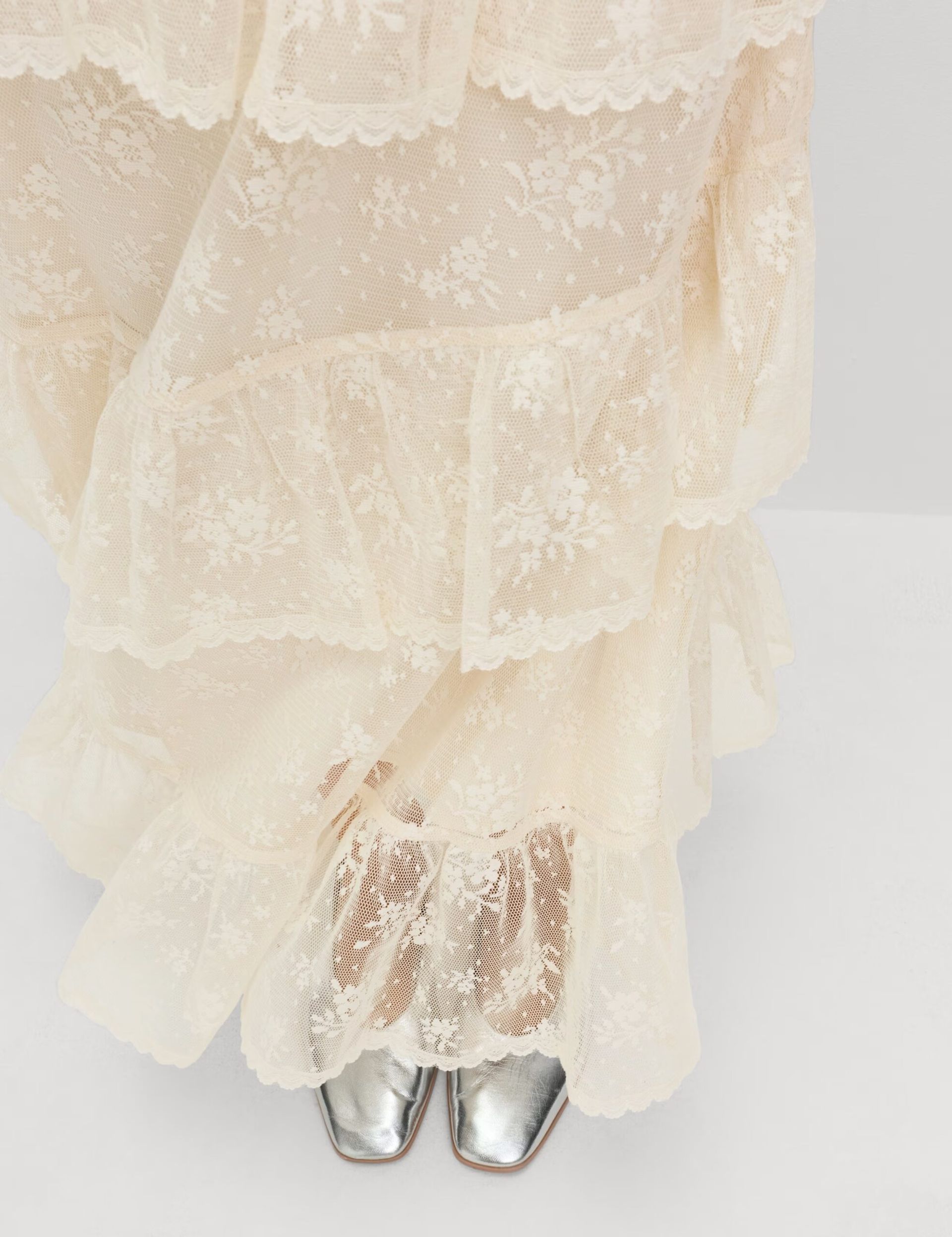close up of M&S Lace Maxi Tiered Skirt and silver shoes