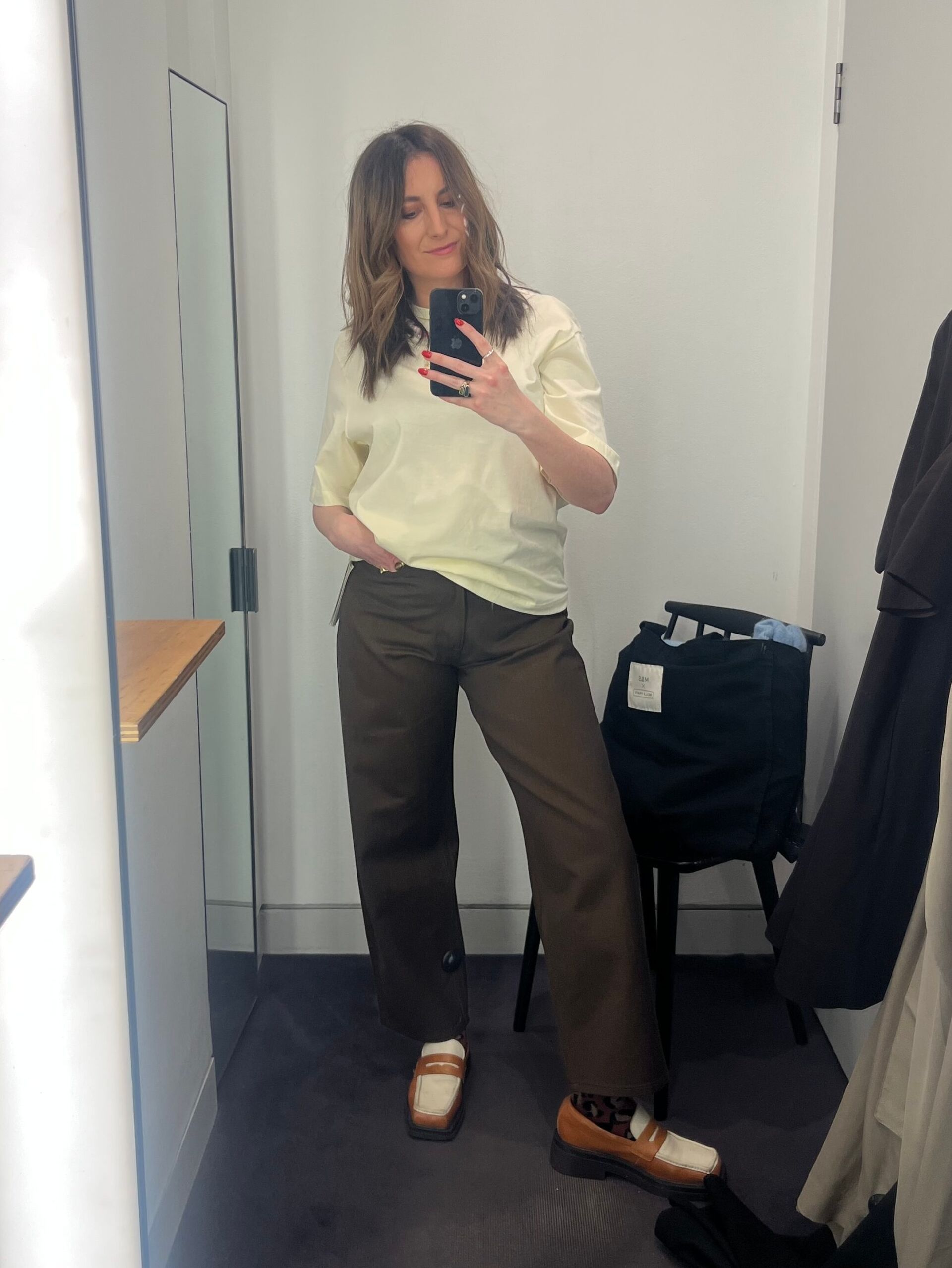 Astrid wearing yellow tee and brown jeans