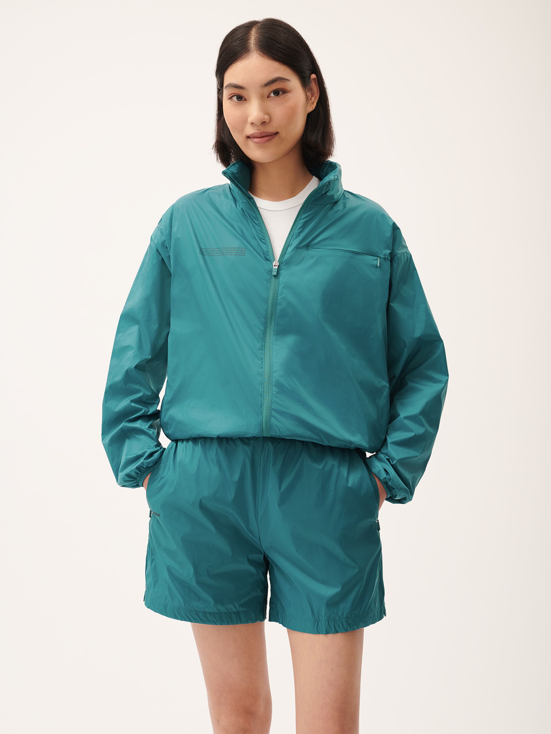 model in teal tracksuit