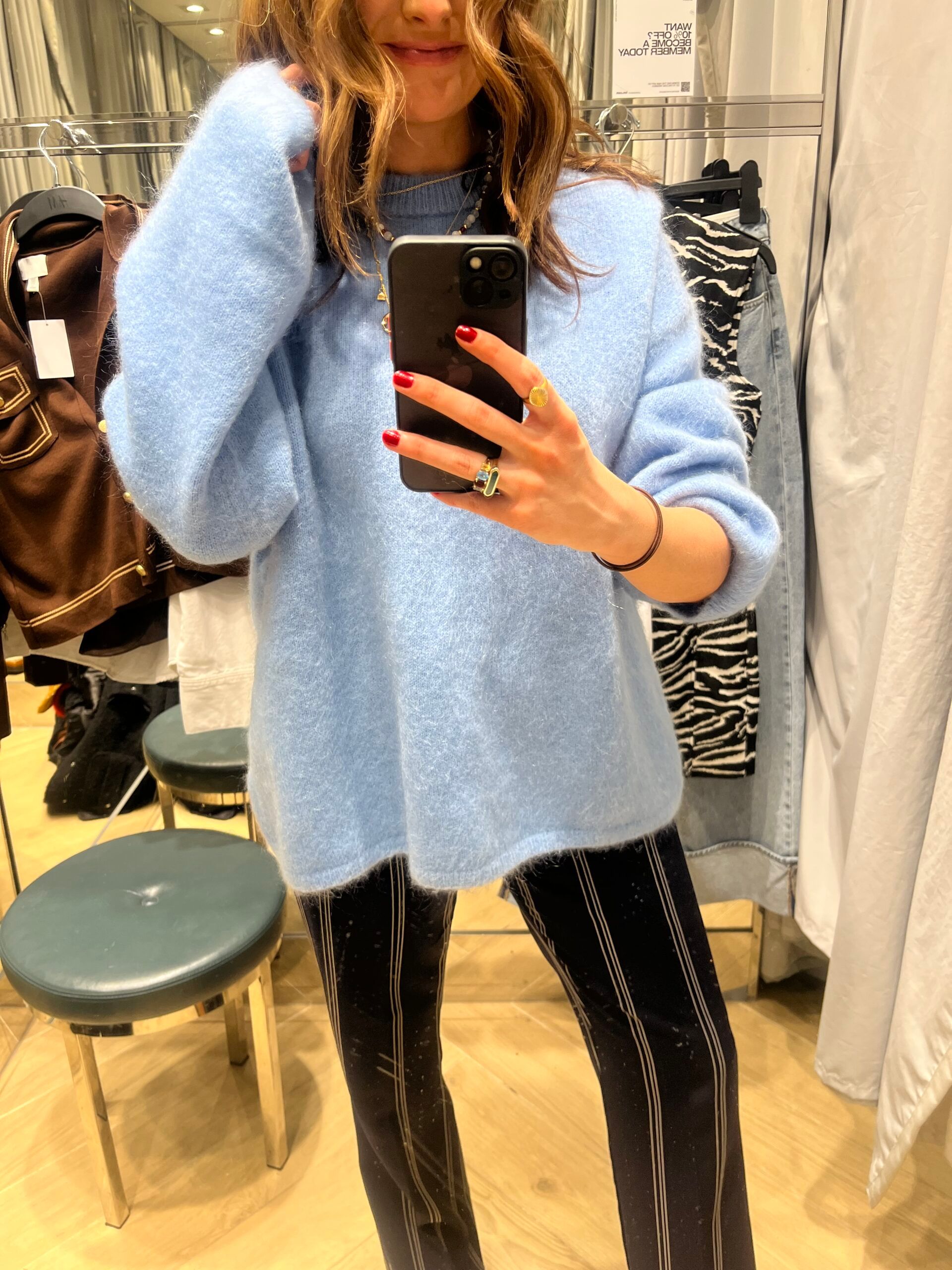 astrid in changing room wearing blue jumper