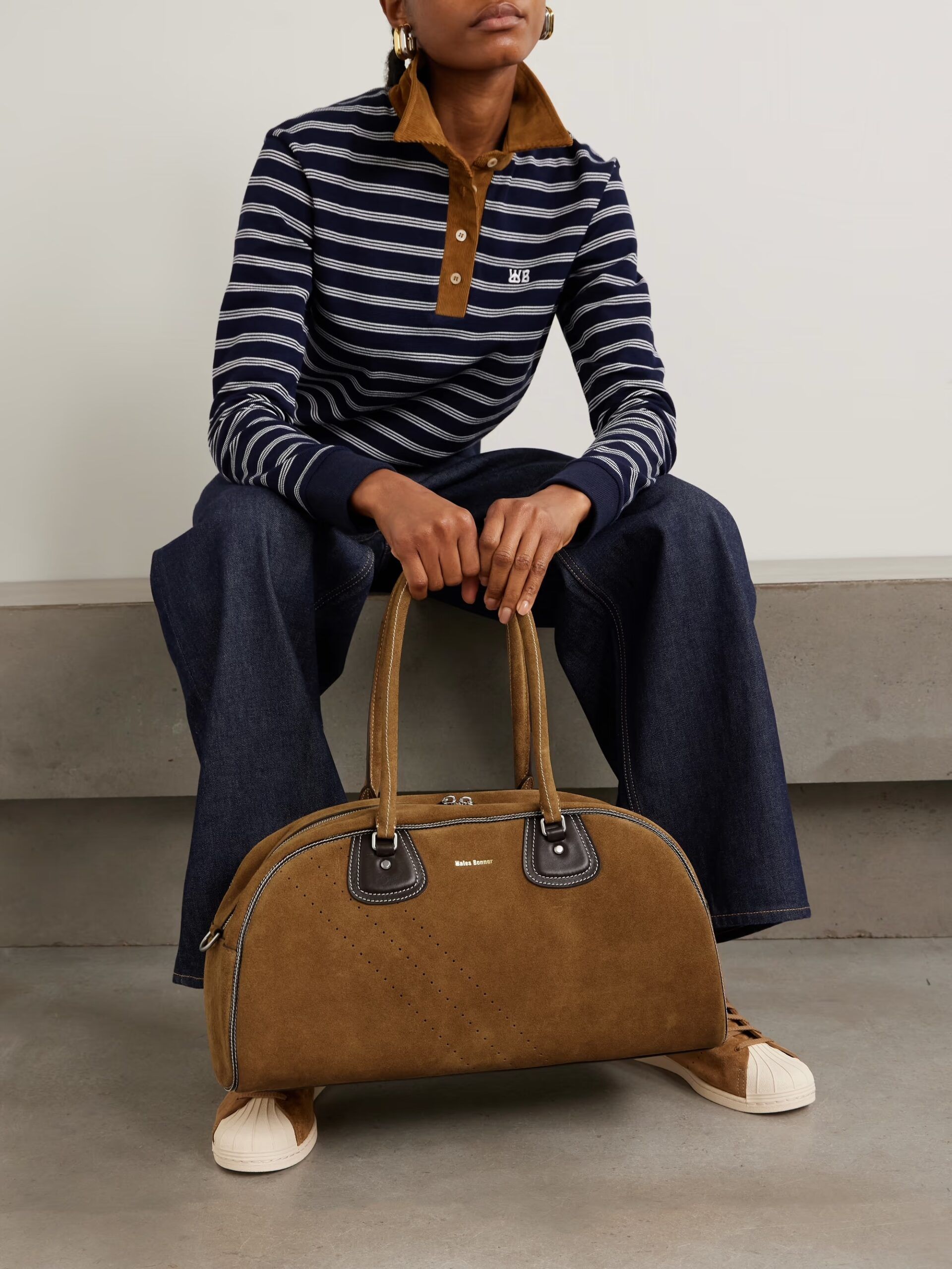 model holding brown suede adidas x wales bonner bag