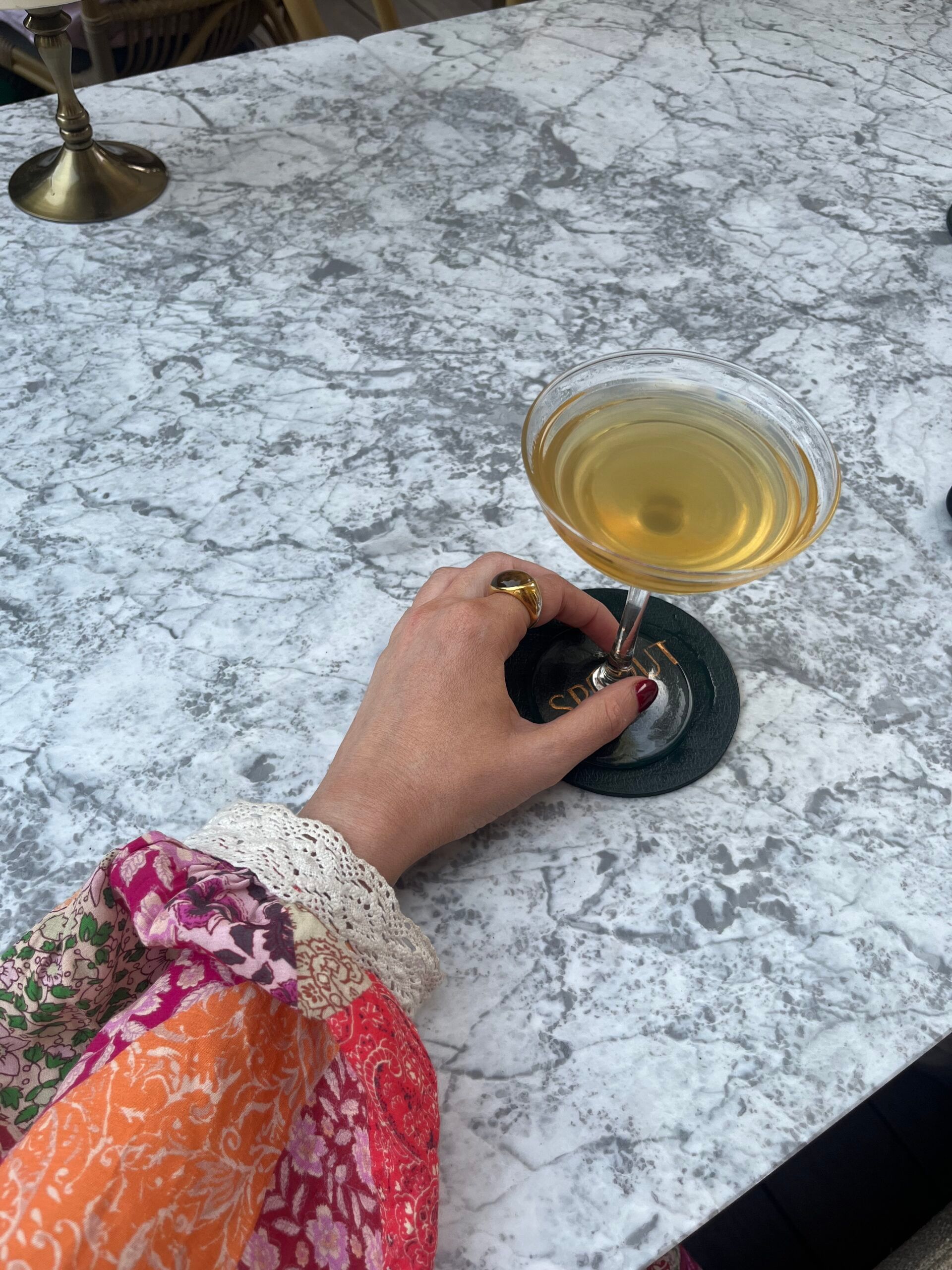 hand on table holding cocktail