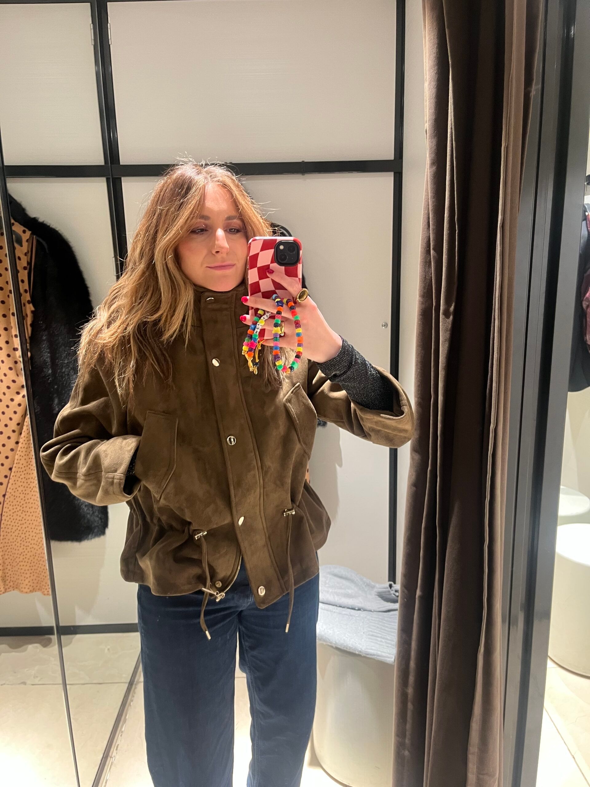 astrid in xra changing room wearing suede jacket 