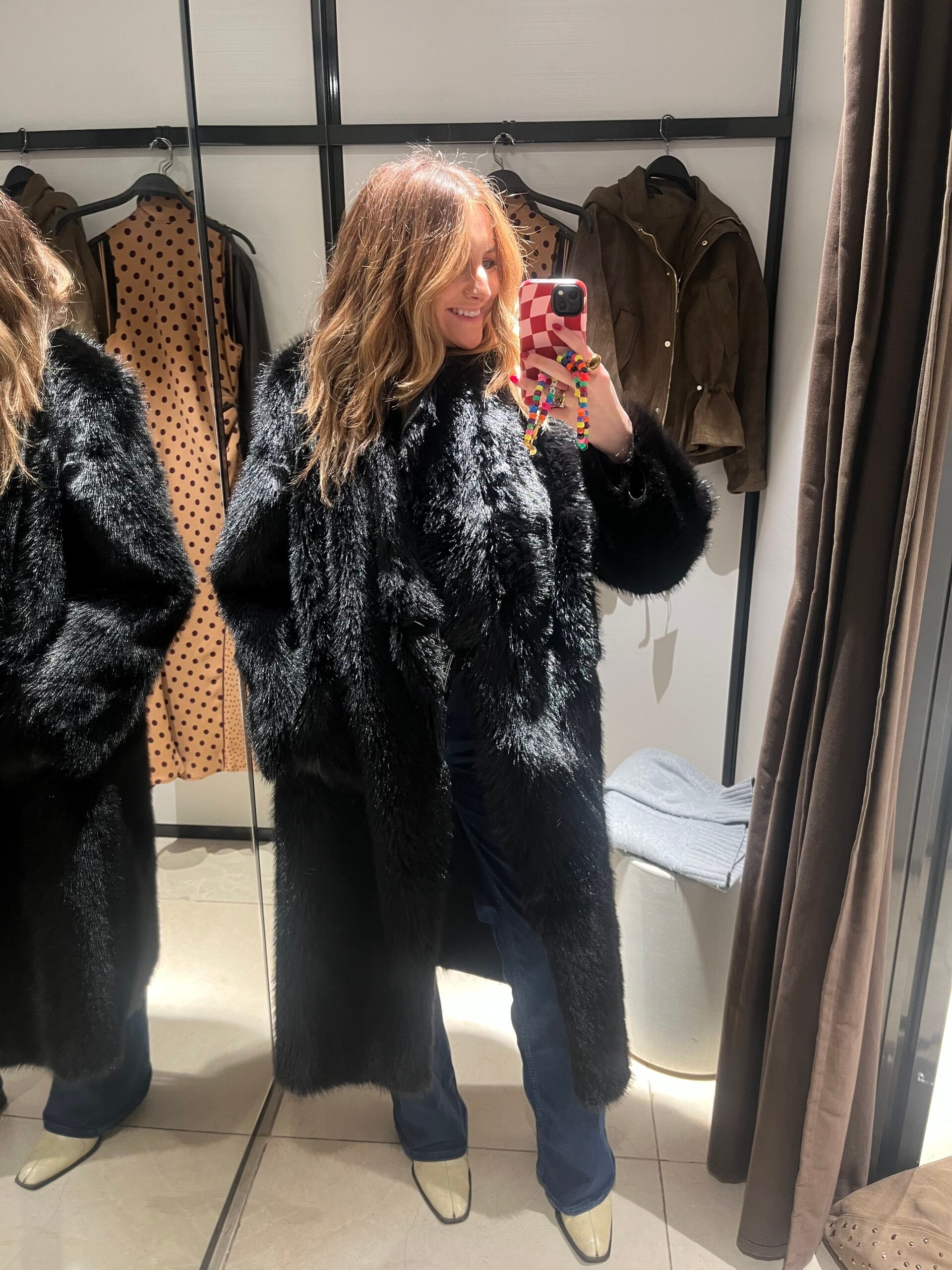 astrid in zara changing room wearing faux fur black coat