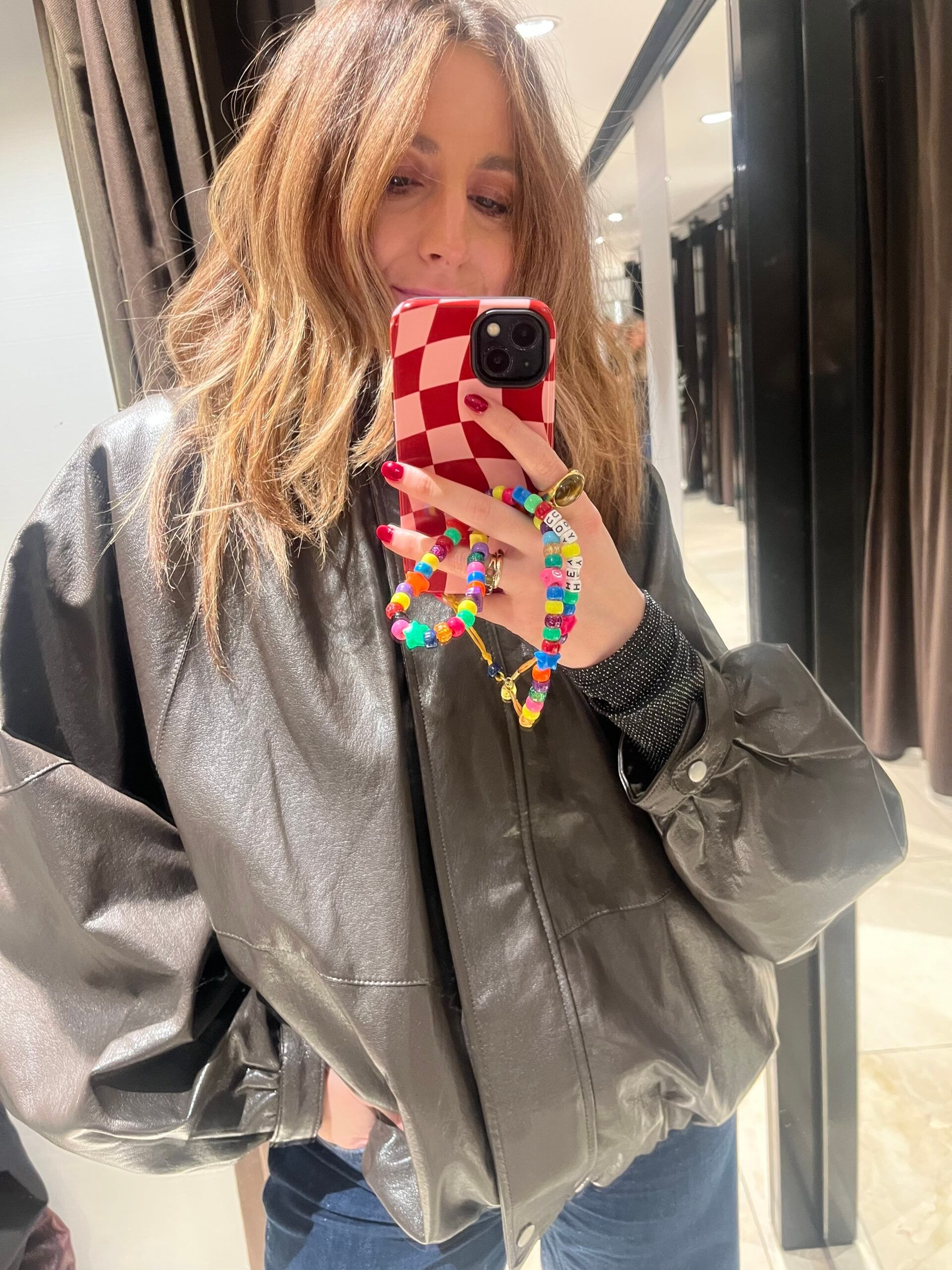 astrid in zara changing room wearing faux leather jacket