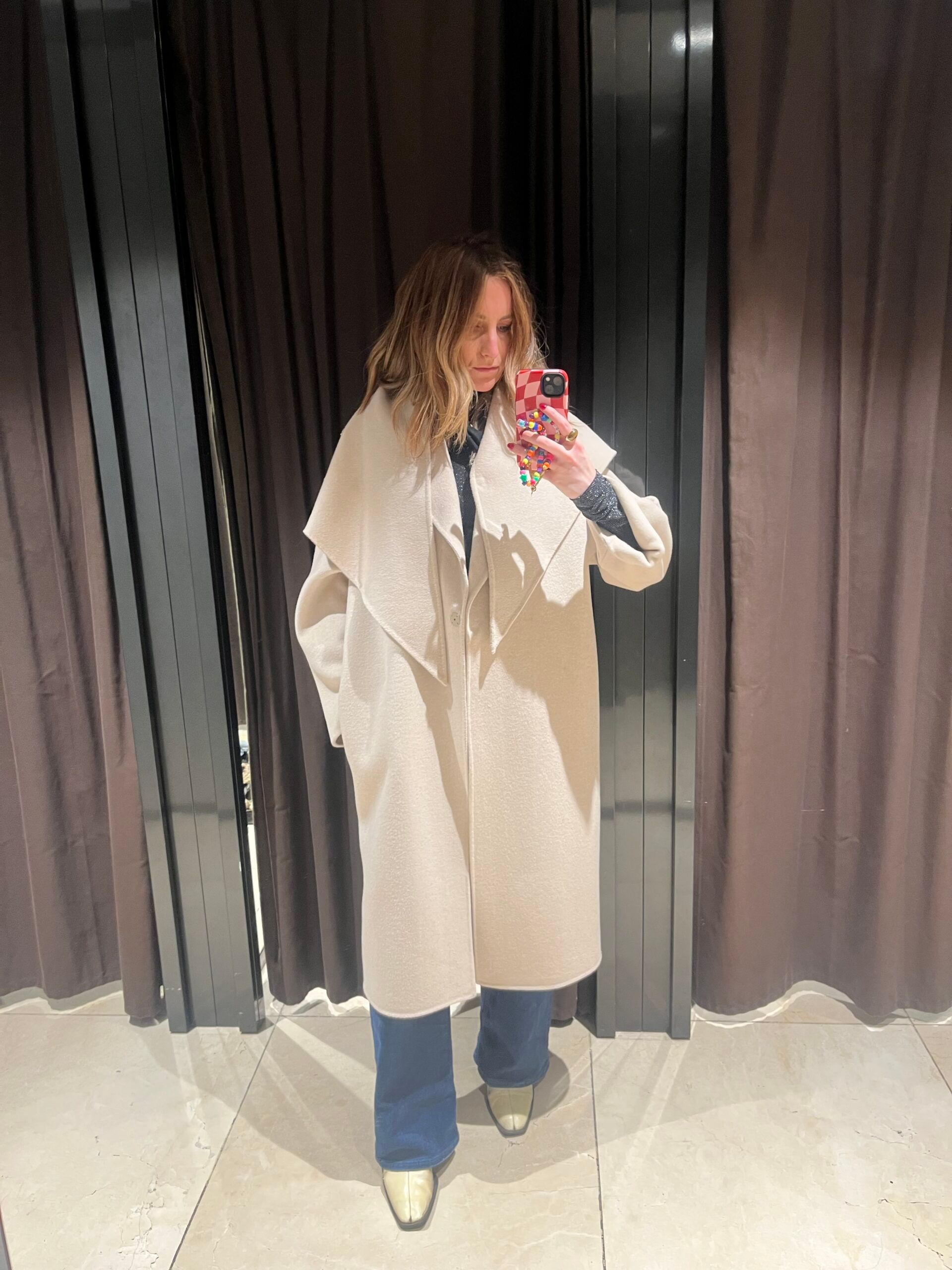 astrid in zara changing room wearing cream coat 
