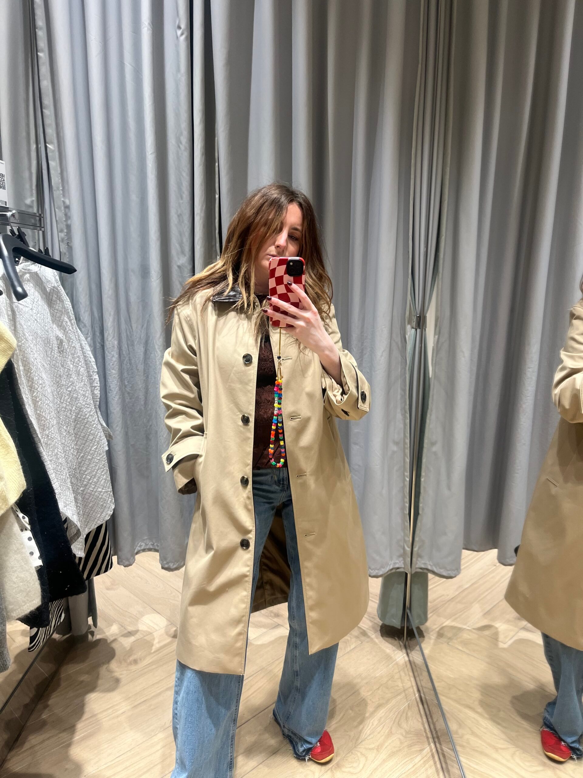 fashion editor astrid carter wearing car coat in store changing room