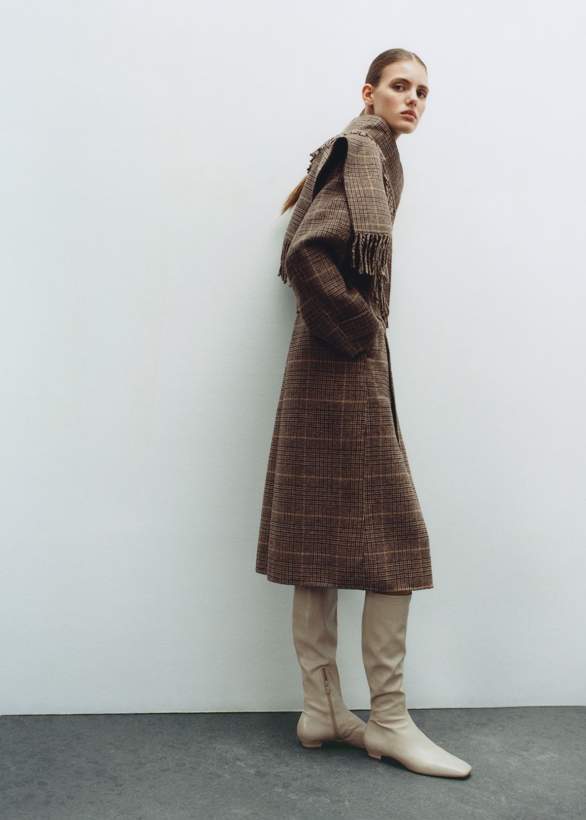 model wearing fringed check coat