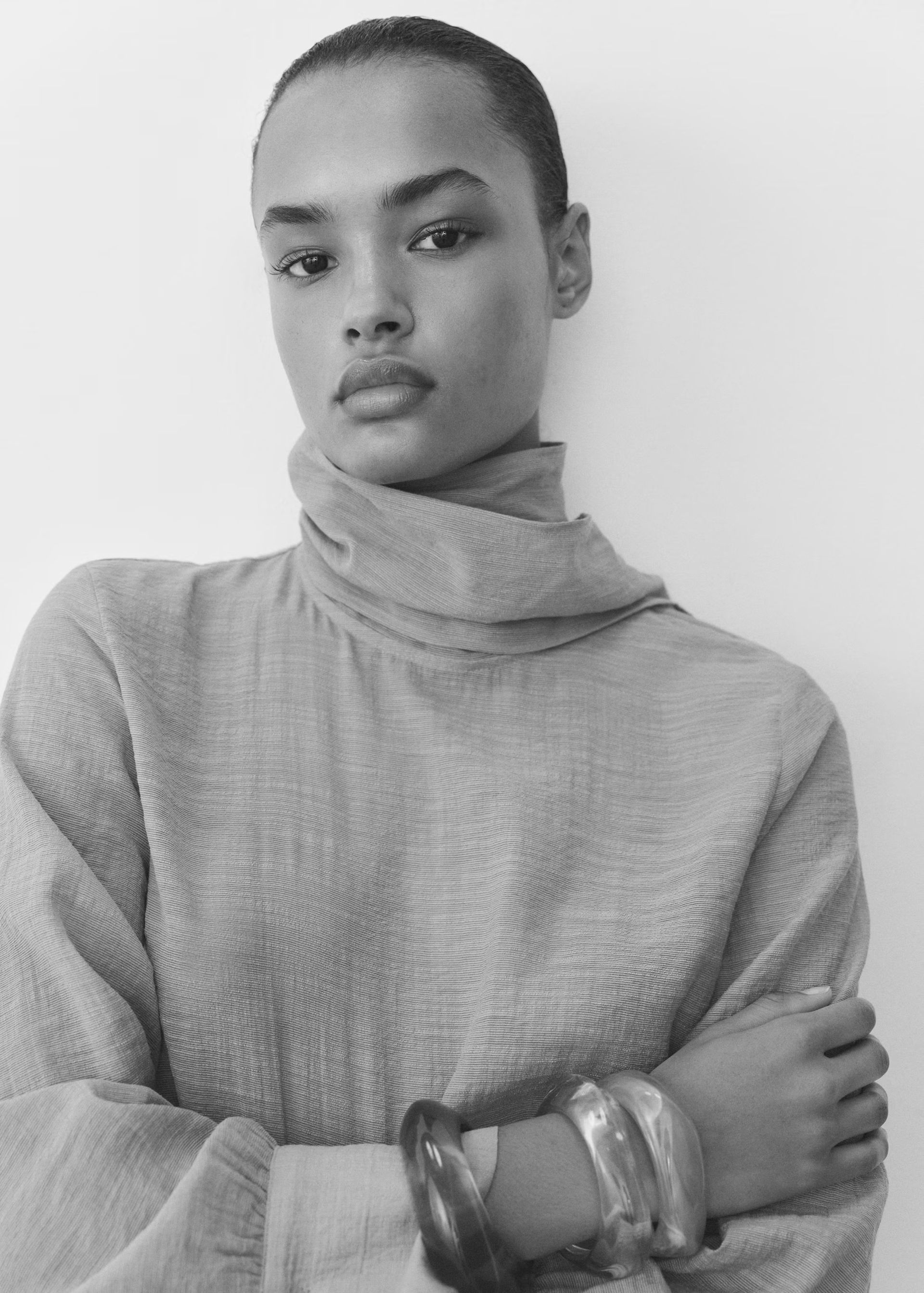 model wearing tie neck blouse