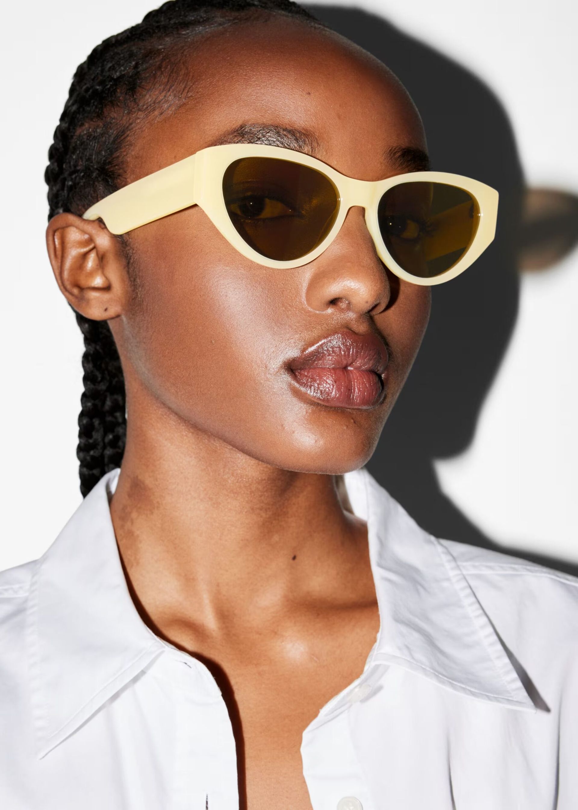 model wearing pale yellow sunglasses