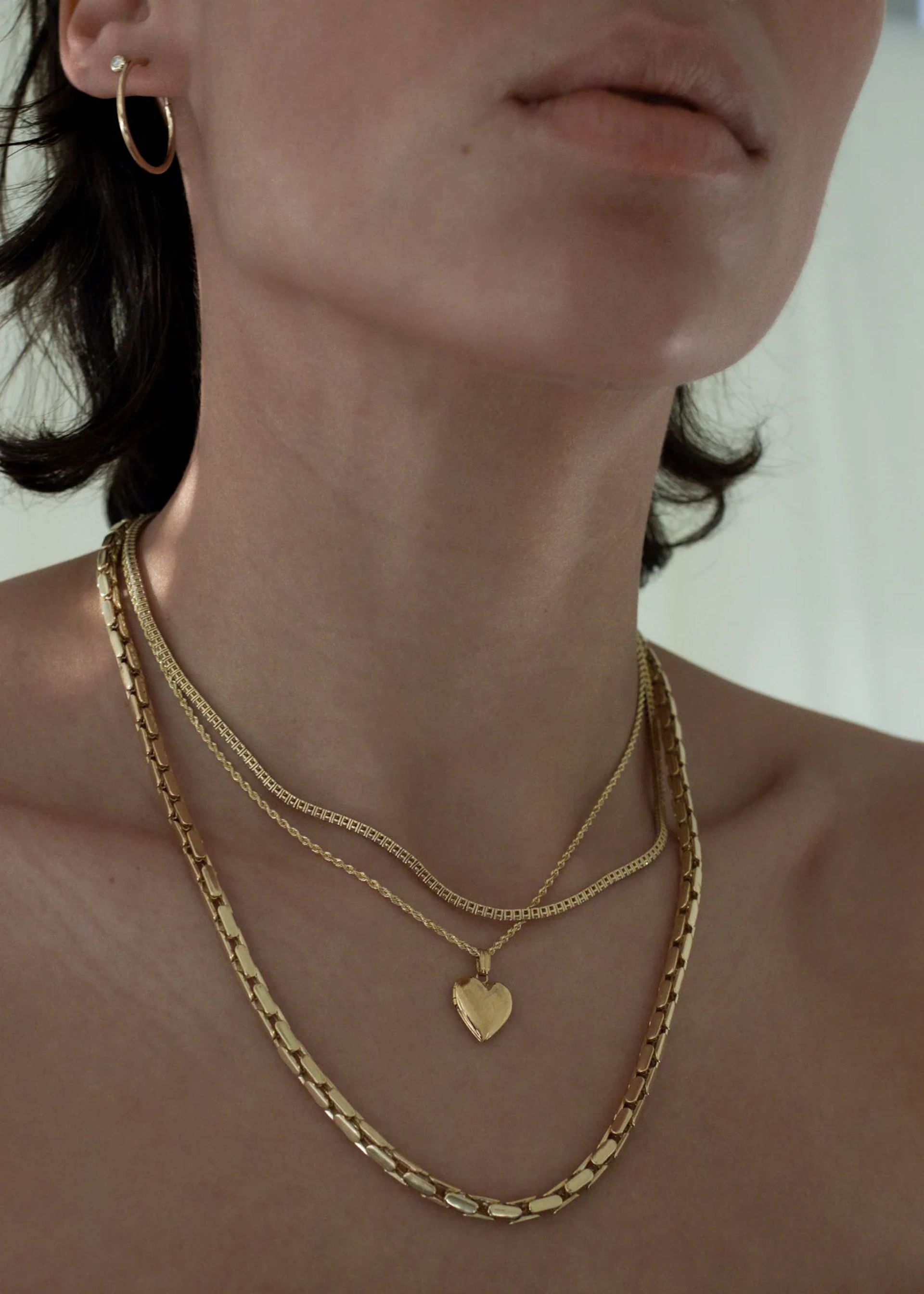 close up of model's wearing necklaces 