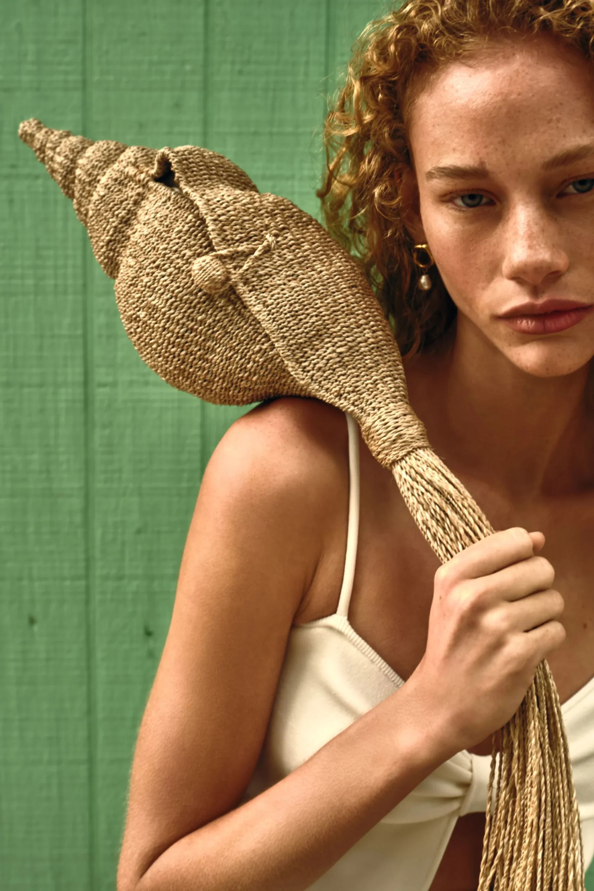 model holding shell raffia bag