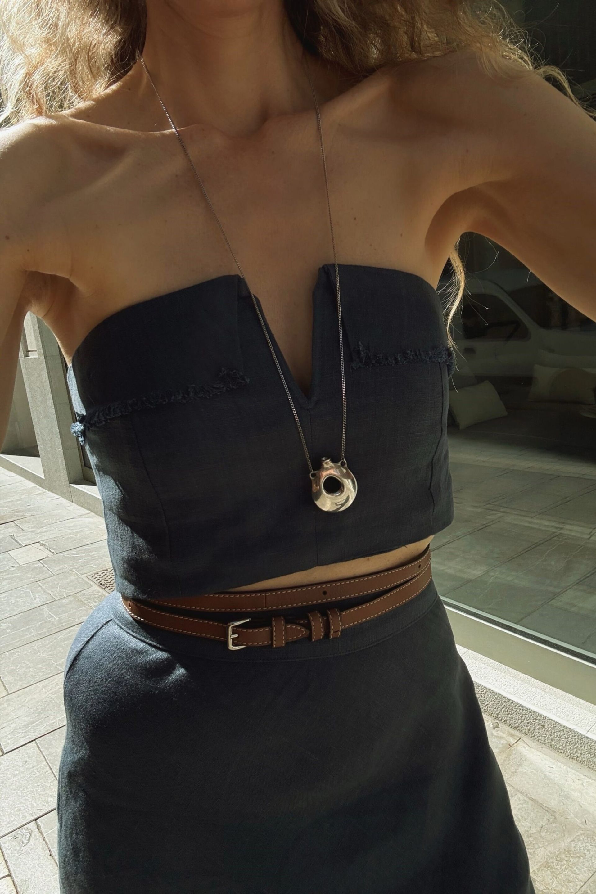 close up of necklace on yve