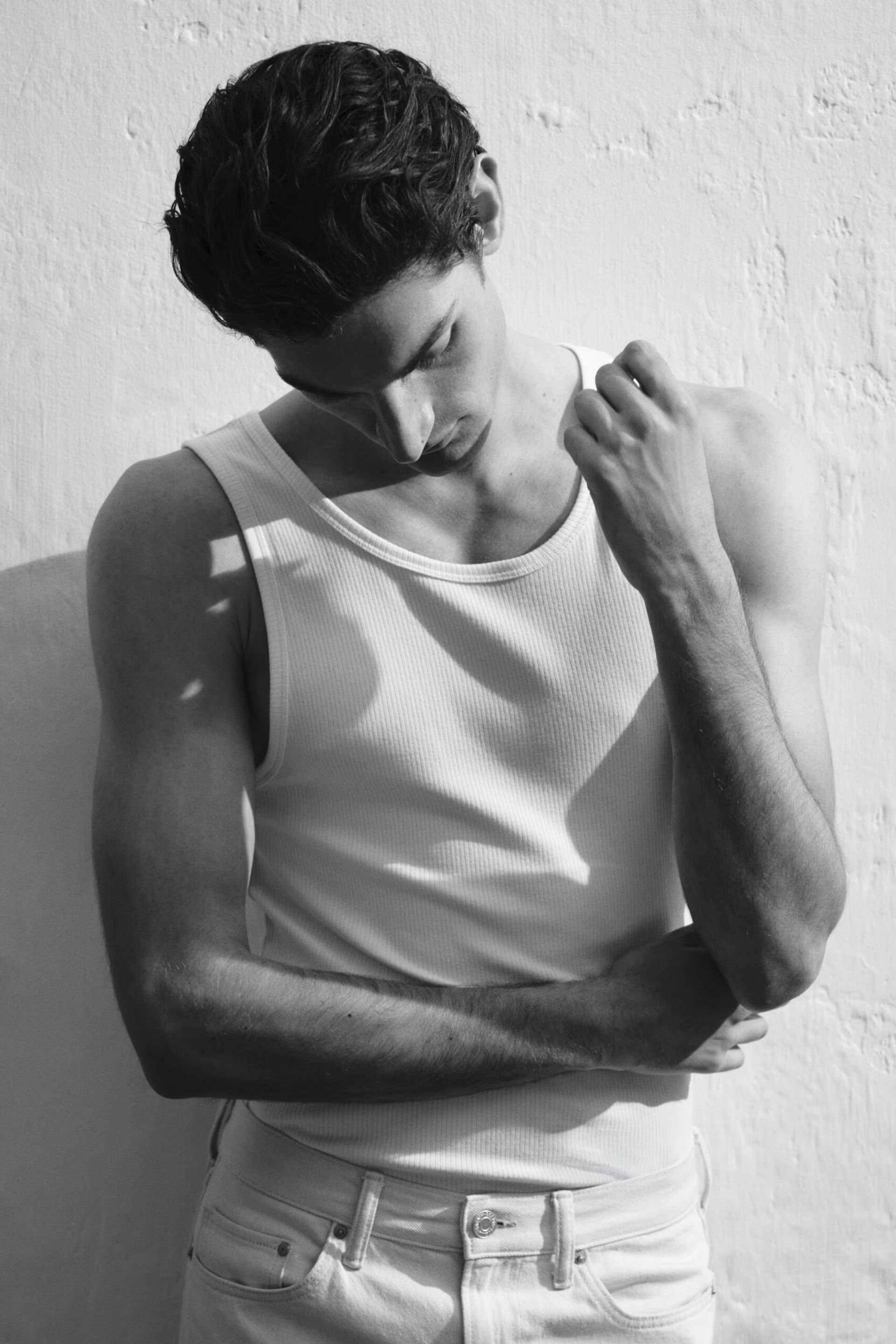 male model wearing white vest 