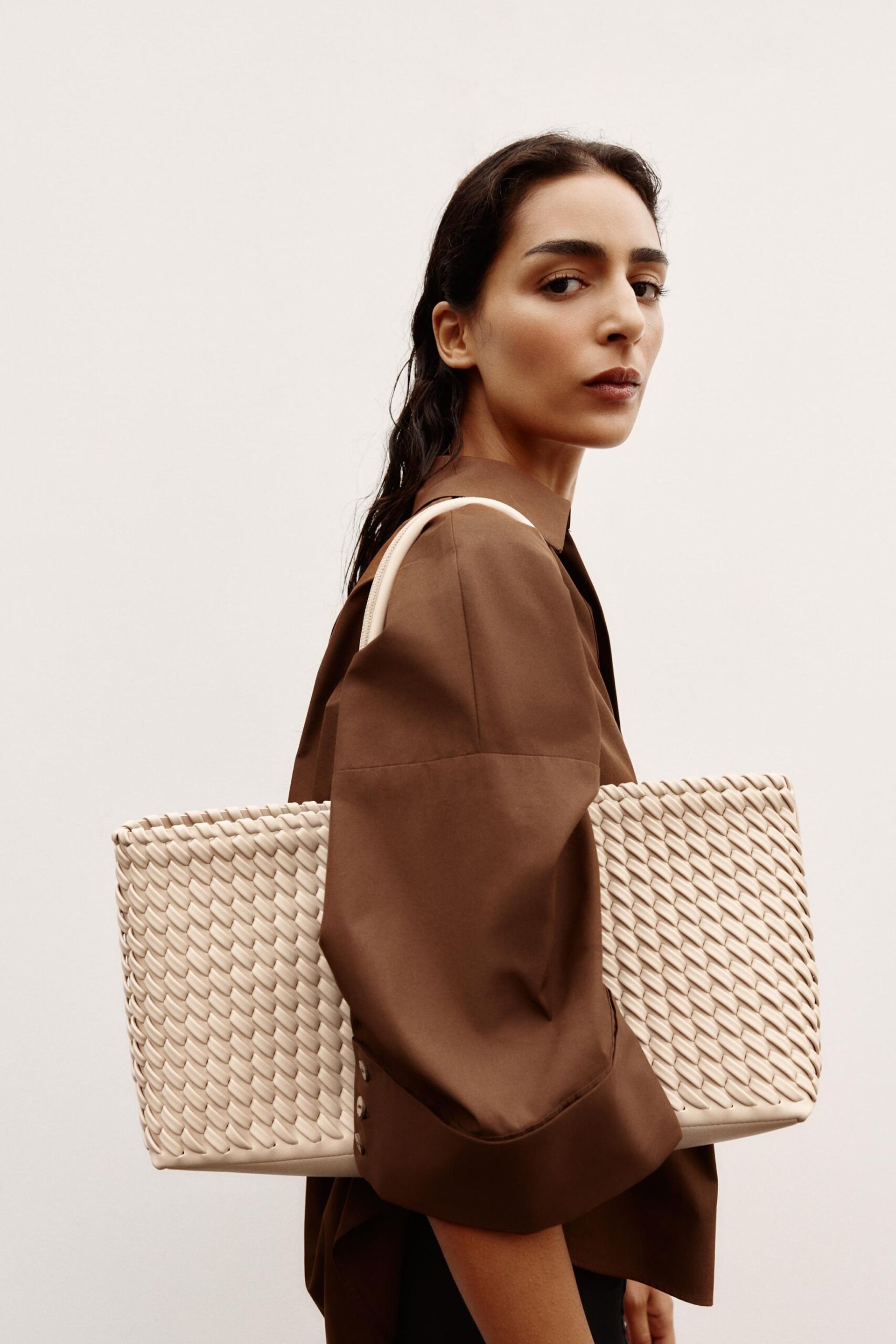 model wearing cream braided tote bag 