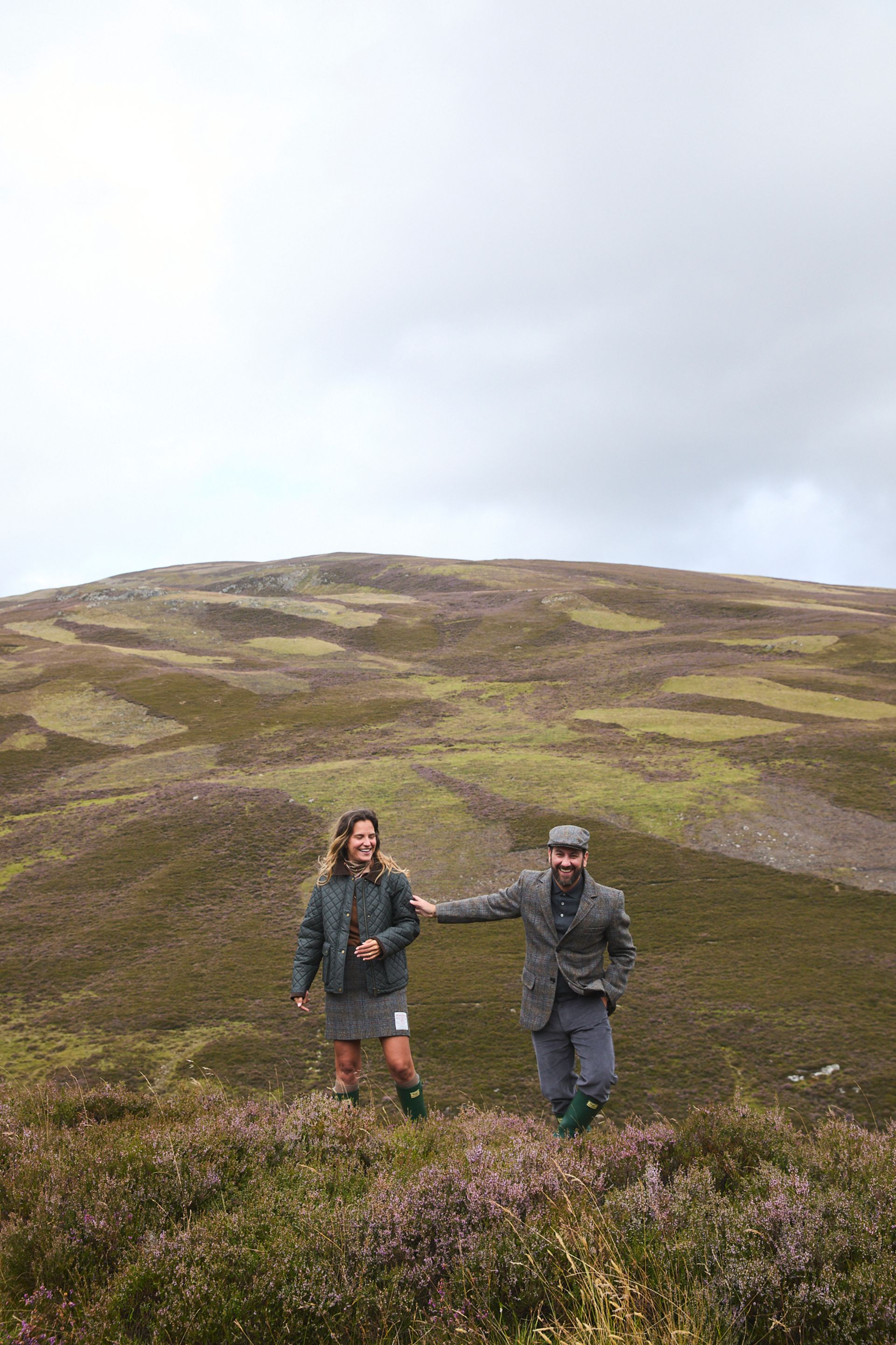 couple on hills wearing harris tweed