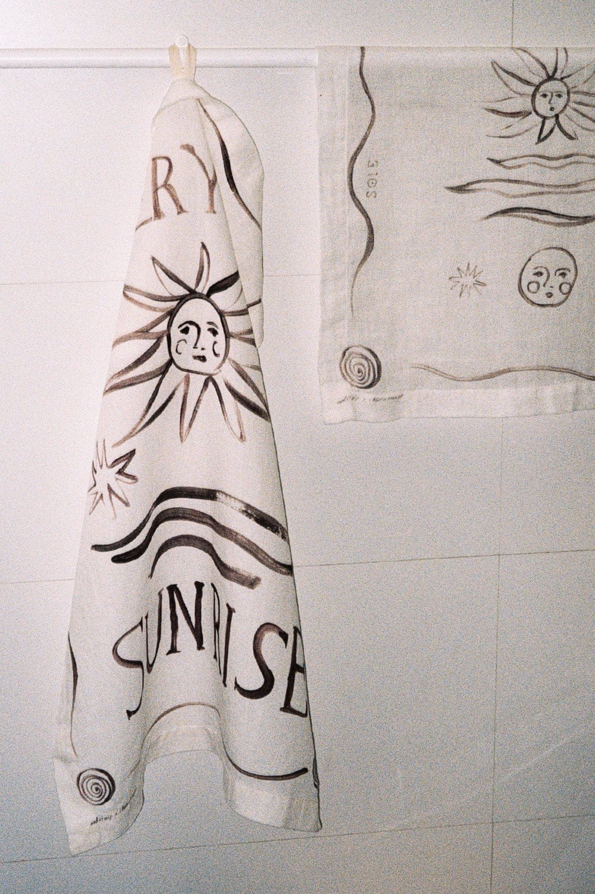 sunrise print tea towel hanging up