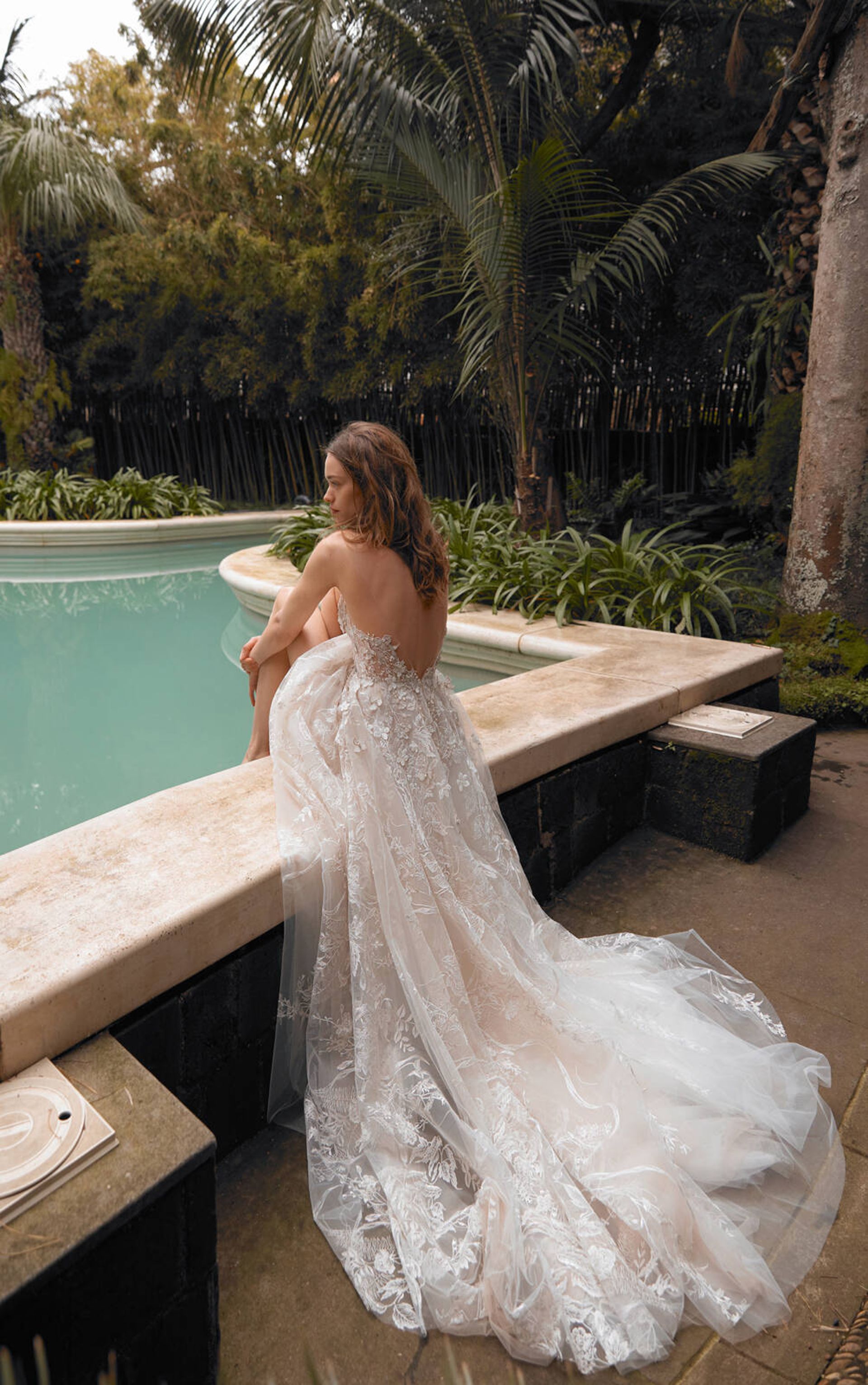model in wedding dress by pool 