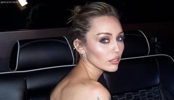 Miley Cyrus Pays Tribute To Hannah Montana In Sparkling Gown At LA Premiere