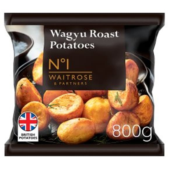 A bag of Waitrose & Partners Wagyu Roast Potatoes, perfect for Easter entertaining, showing golden roast potatoes on a black plate. The packaging displays the weight (800g) and a British Potatoes logo.