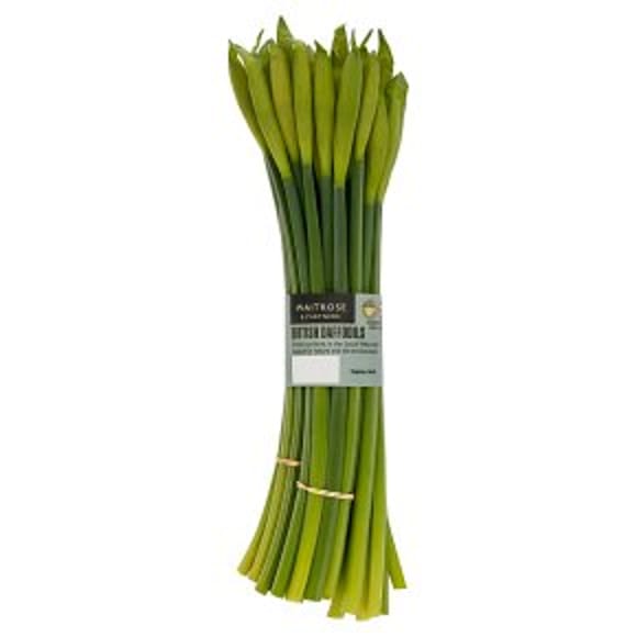 A bunch of fresh, unopened yellow daffodil flower stems, bundled together with elastic bands and wrapped with a label reading British Daffodils—perfect for brightening up your home or Easter entertaining.