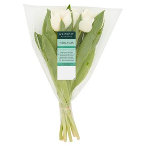 A bouquet of white tulips with green leaves wrapped in clear plastic packaging, labelled Waitrose & Partners Pastel Tulips—perfect for Easter entertaining.