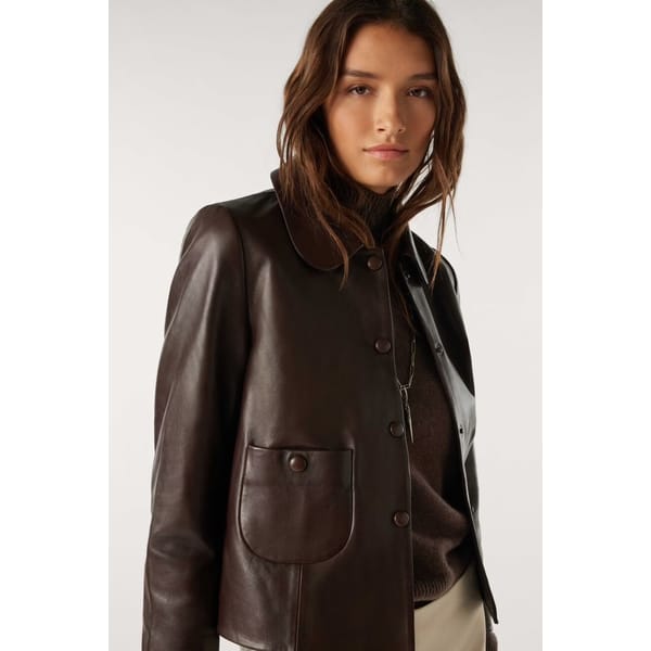 model wears brown leather jacket
