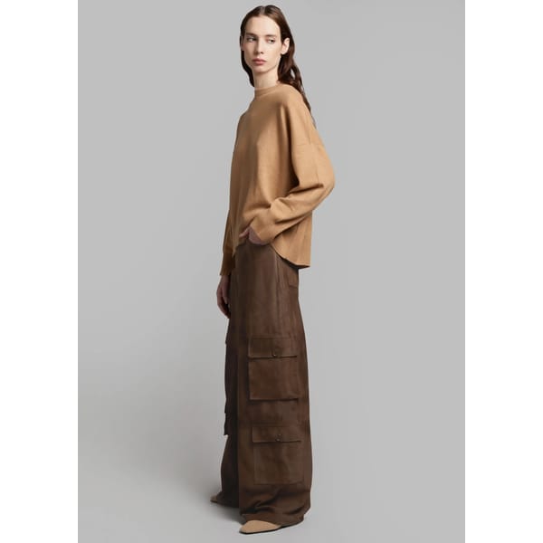 model wears brown cargo pants and yellow top