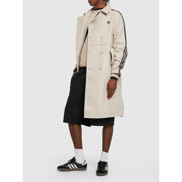model wearsAdidas Originals 3-Stripes tech trench coat