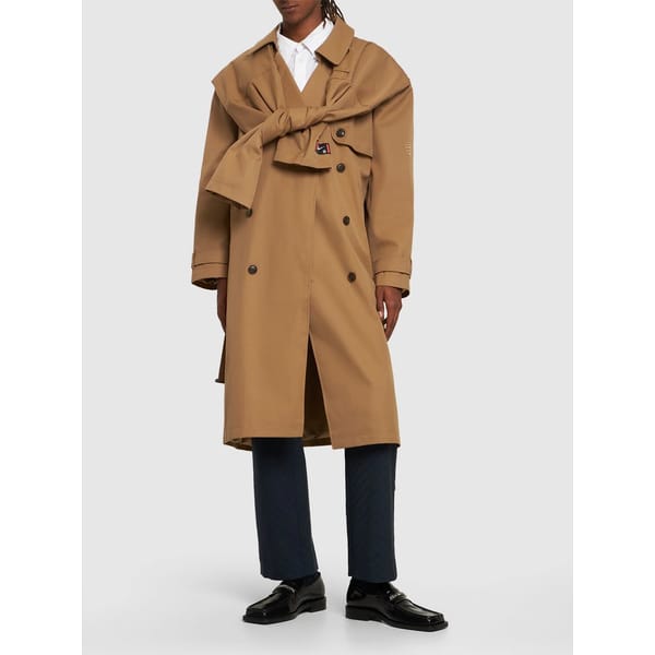 model wears brown trench with sleeve detail