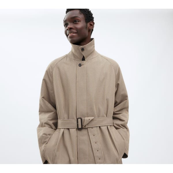 model wears checked trench