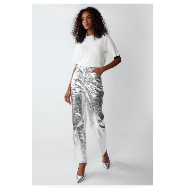 model wears silver trousers