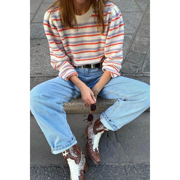 model wears stripe jumper and jeans