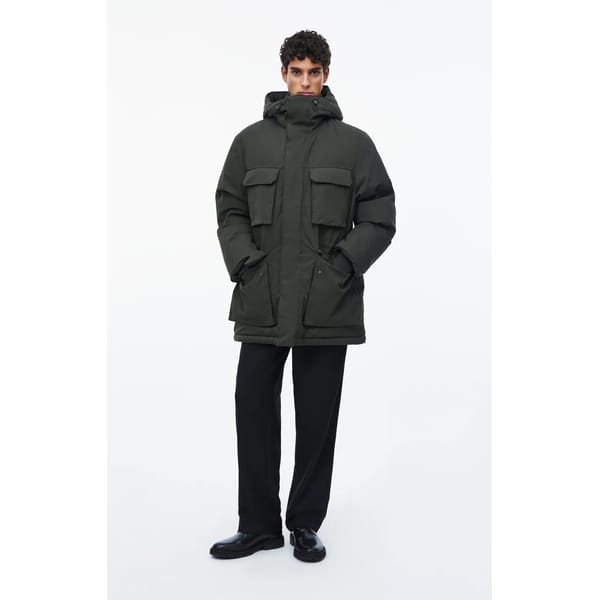 model wears green parka jacket