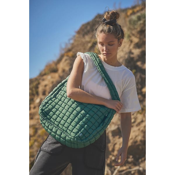 model wears green FP Movement Quilted Carryall