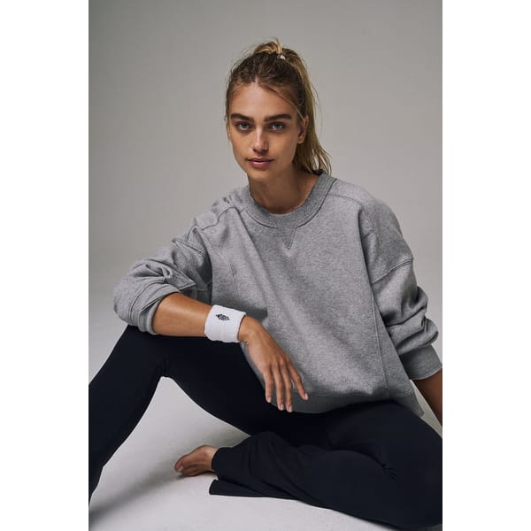 model wears grey marl sweater