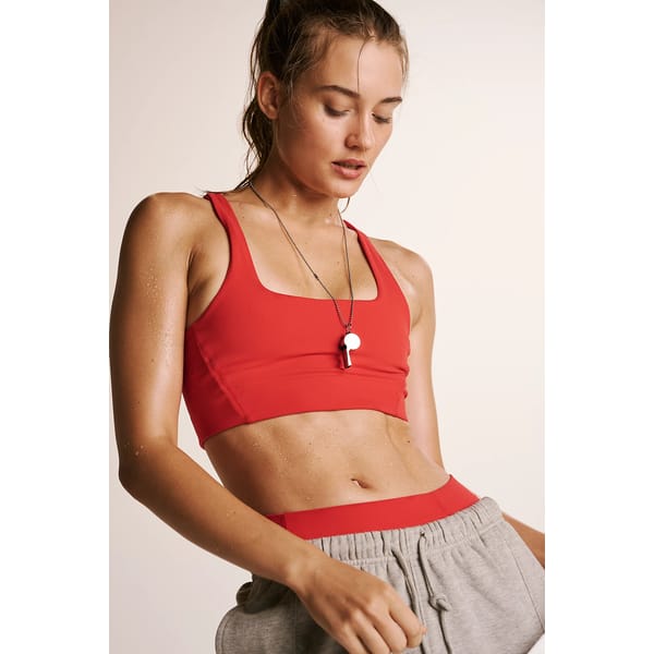 model wears red sports bra
