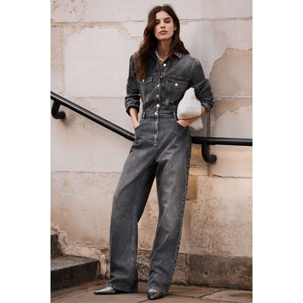 model on stairs wearing denim jumpsuit