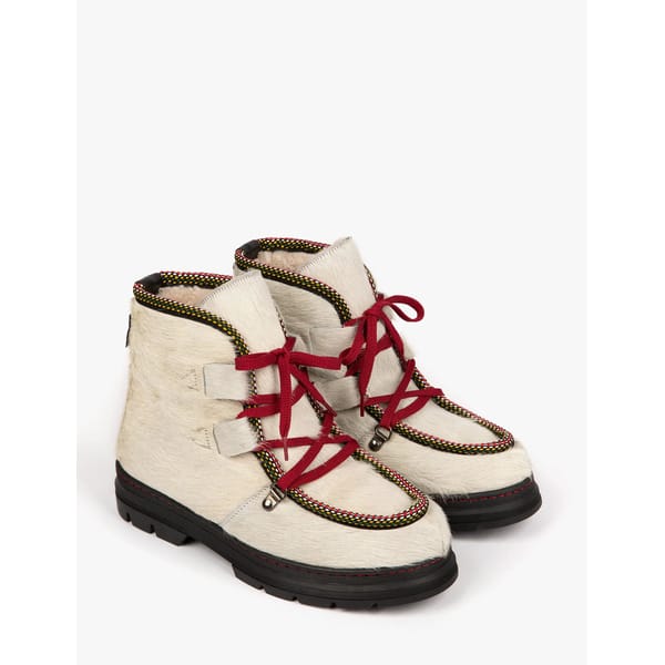 white fur hiking boots with red laces