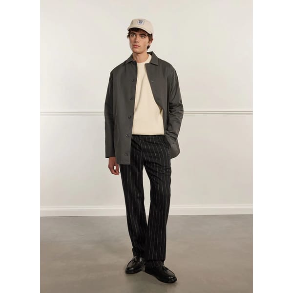 model wears men's raincoat