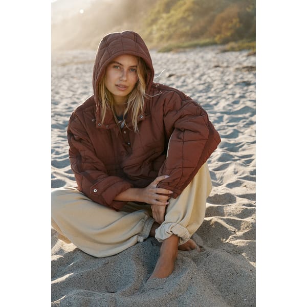 model on the beach in puffer jacket