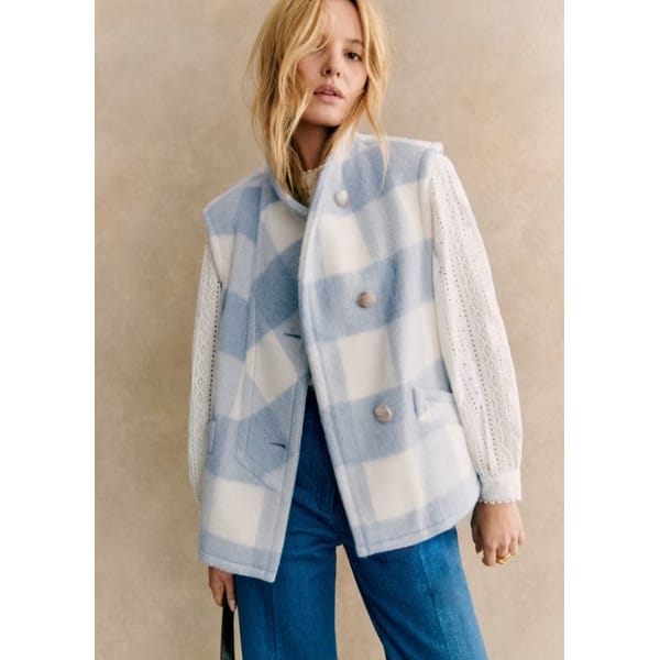 model wears blue check jacket