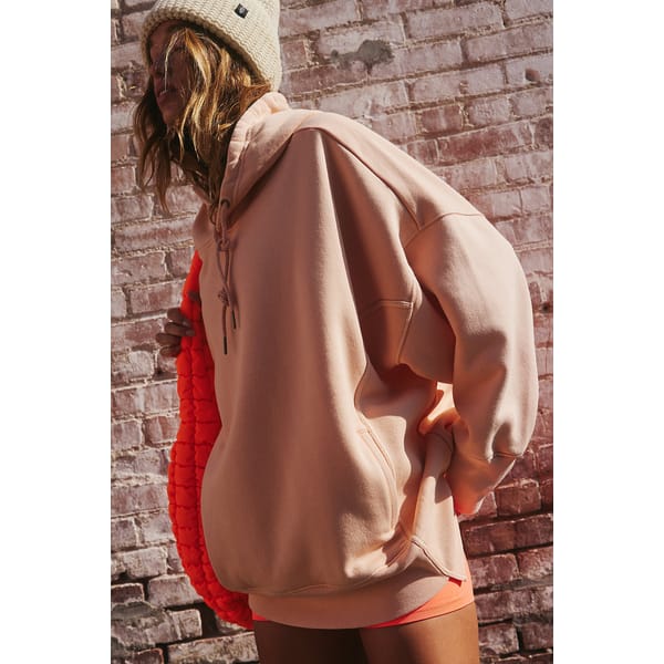model wears pink hoodie and hat